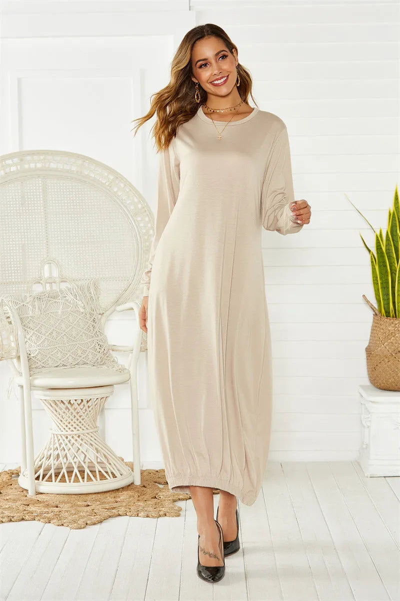 Black lace-up crew neck loose knit lantern dress on a model, showing the lantern silhouette.