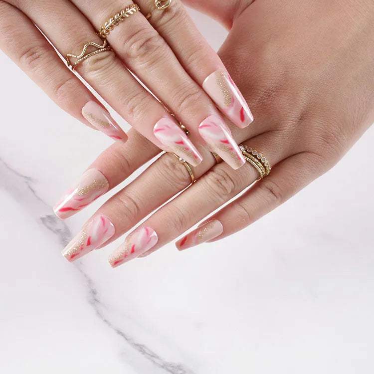 One Second Wearable Manicure set showing 24 blush-coloured false nails with rose, tulip, leopard print, and XINGX patterns and glue.
