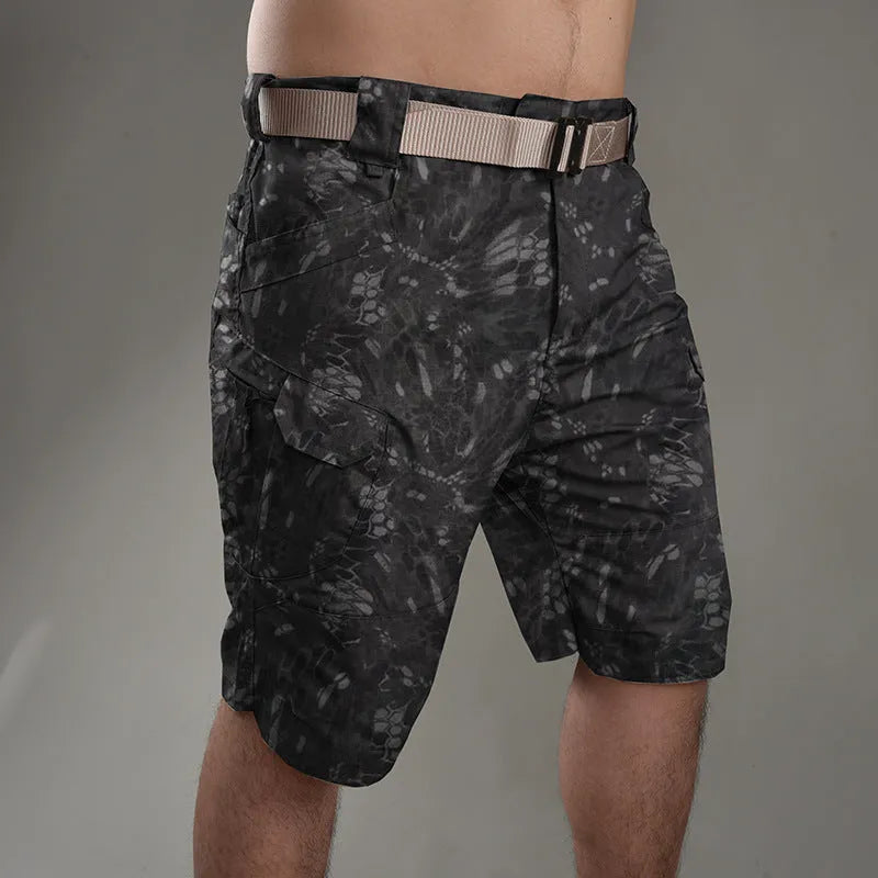 IX7 men's tactical shorts in cotton blend fabric, shown in a camouflage colour with button-fly closure.