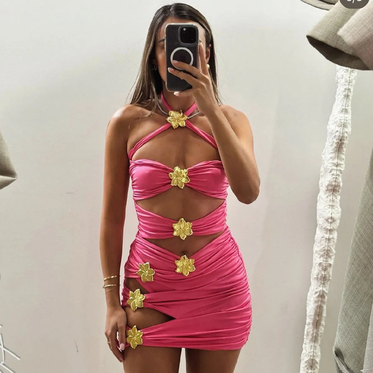Women's solid colour one-piece swimsuit with high waist and matching short skirt.