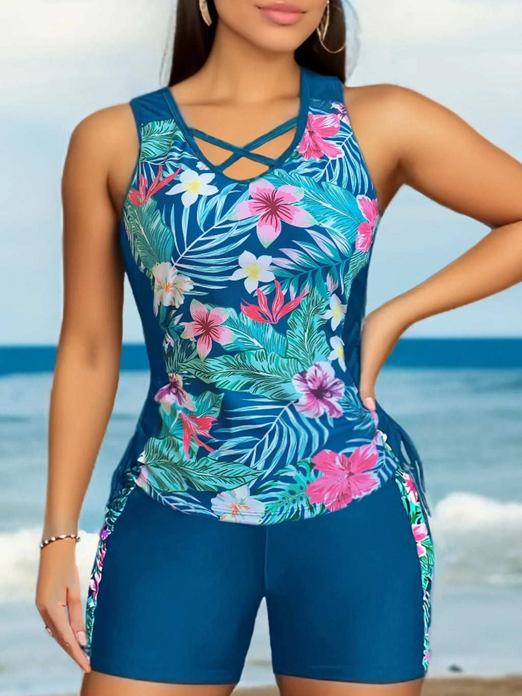 Women's plus size floral high-waist swim bikini in blue on a neutral background.