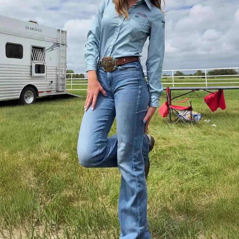 Slim fit blue embroidery jeans with slight flare and mid-waist rise on a neutral background.