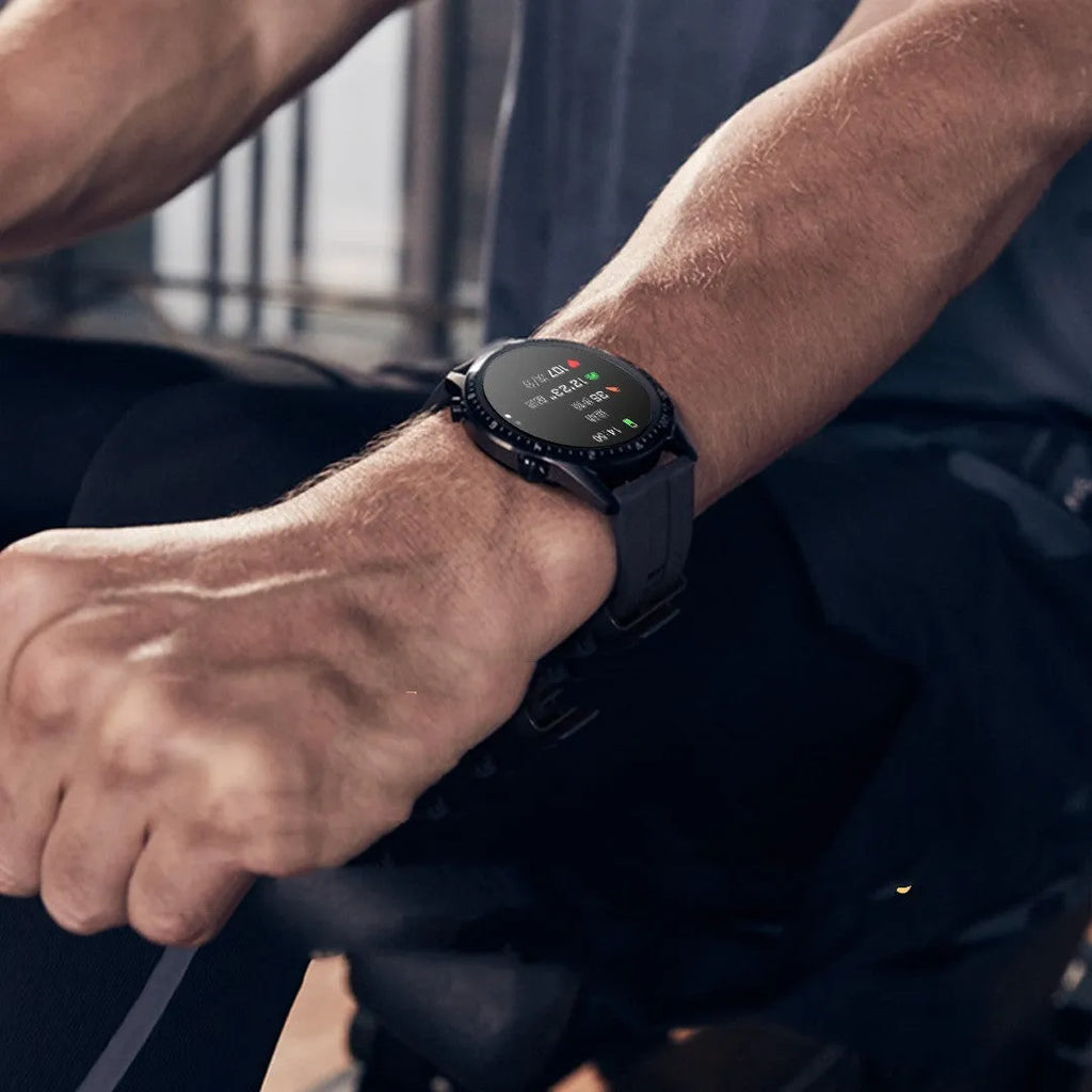 Round aluminium smart watch with Bluetooth calling on a wrist, showing a black watch face.