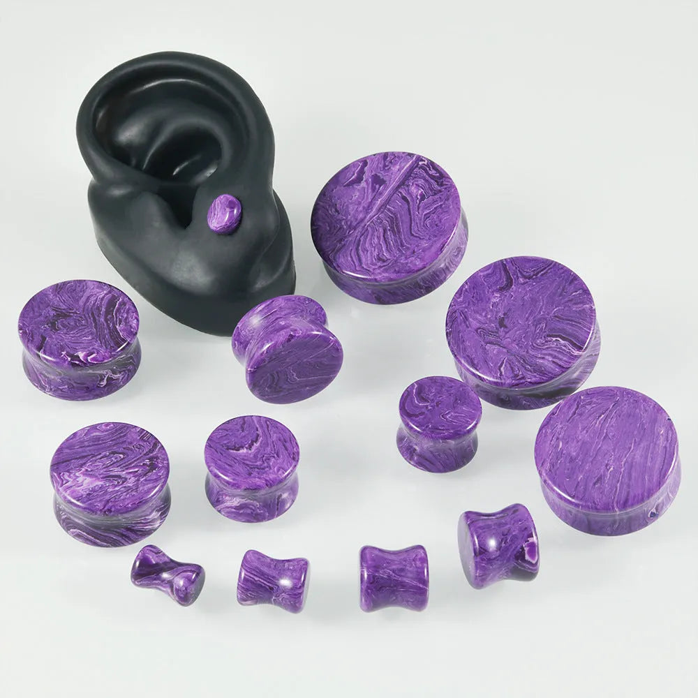 Crystal red flower stone solid expansion earplug on grey background, 6mm to 30mm sizes available, unisex geometric design