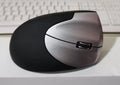 Black wireless vertical mouse with 2.4GHz USB connection, 1200dpi photoelectric sensor, three buttons, and full-size rat shape for desktop use.