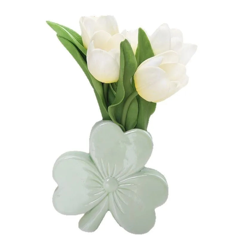 Clover white porcelain ceramic vase in European style on a desk.