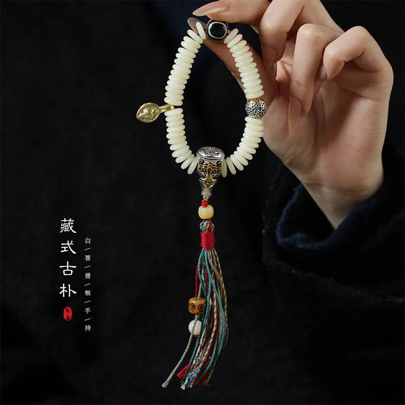 Close-up of a White Bodhi seed bracelet or handheld strand showing 3x10mm natural beads.